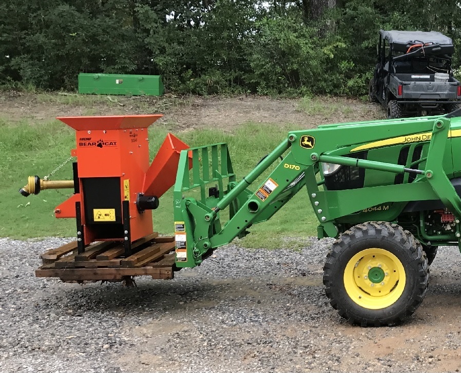 John Deere 4044M Tractor with Echo Bear Cat on Pallet Forks