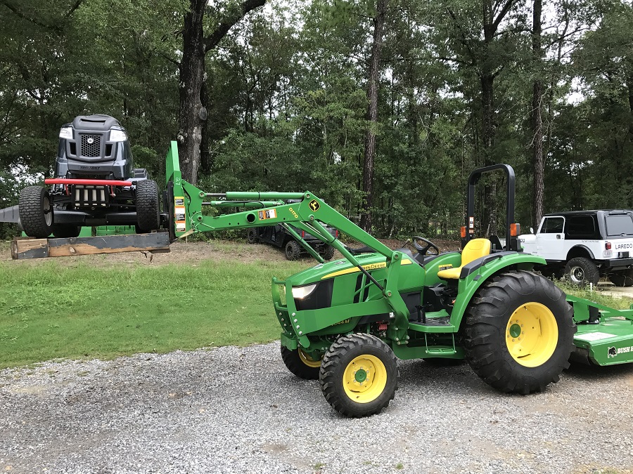 John Deere 4044M carrying Troy-Bilt Super Bronco Left Side